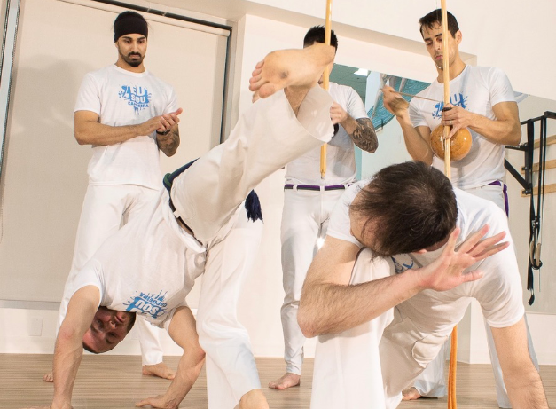 two people playing capoeira